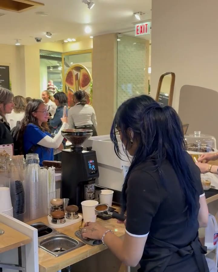 Baristas working the counter at a Citrus & Olive espresso bar