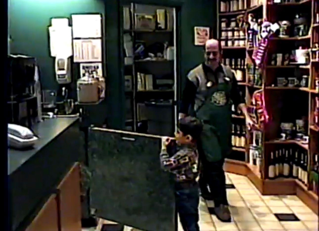 Young Muaz with his father behind the counter at Gloria Jean’s