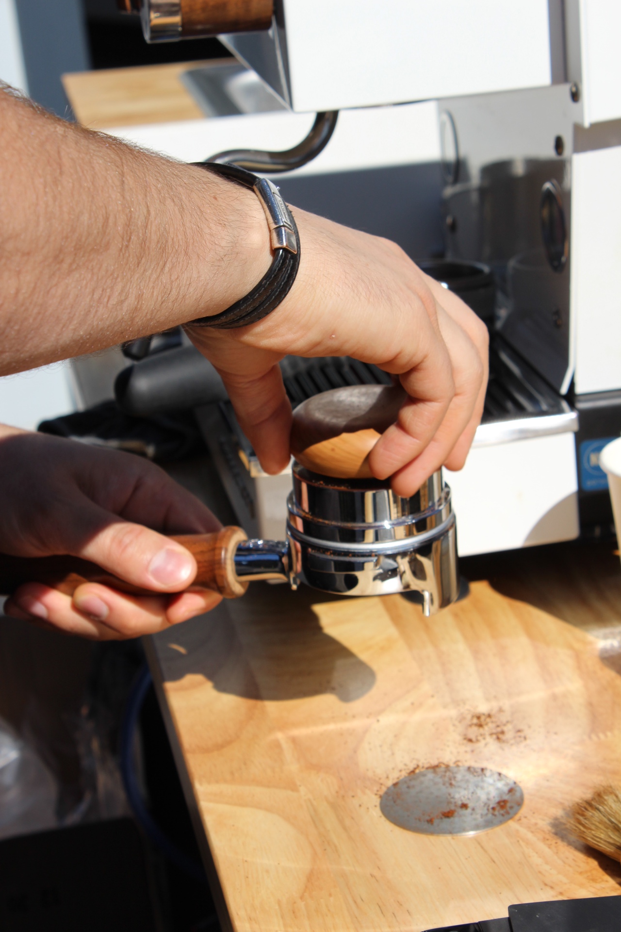 Close-up of espresso tamping and bottomless portafilter — Citrus & Olive craft
