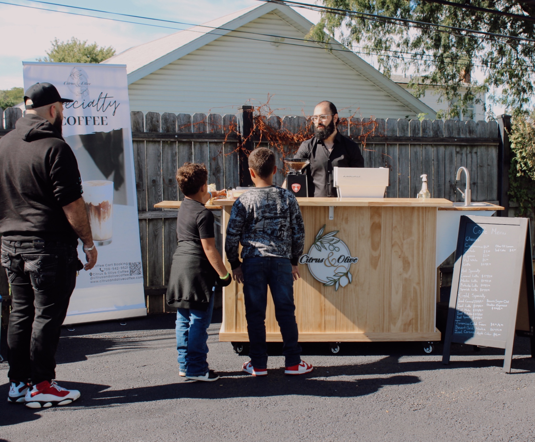 Muaz Bondokji serving espresso at a community event — Citrus & Olive Chicago