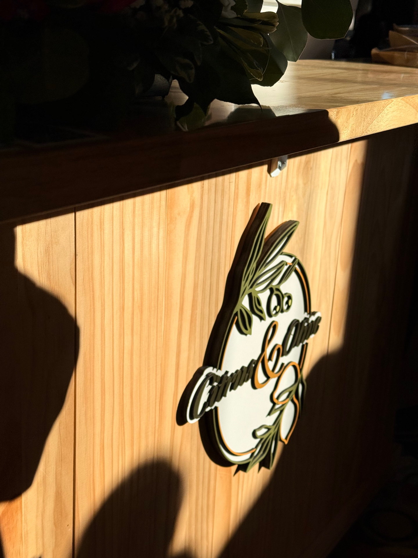 Citrus & Olive logo detail in afternoon sunlight