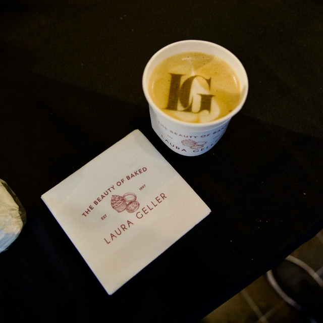 Laura Geller LG monogram printed on the foam of a latte in a branded cup